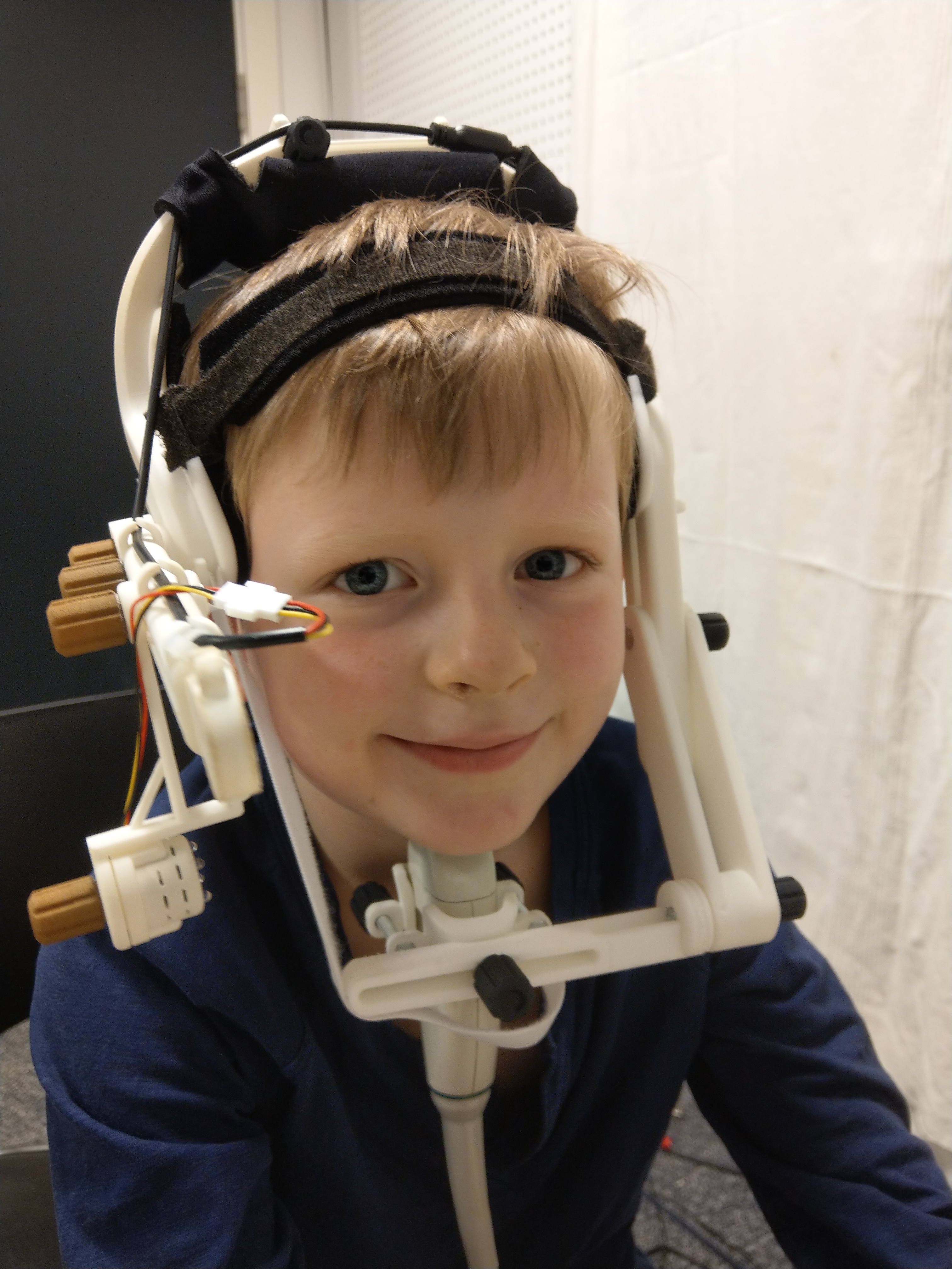 a child wearing the ultrasound probe stabilising headset